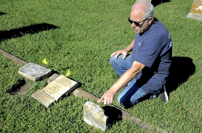 <p>Democrat photo/Michelle Brooks</p><p>Jamestown historian Peter Schlup looks at some of the oldest headstones in the Concord Cemetery.</p>