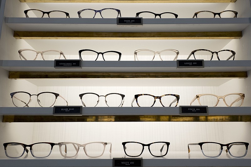 Warby Parker eyewear is displayed at a company retail store, Wednesday, Sept. 6, 2017, in New York. At Warby Parker, you can pick out five frames to try for five days for free. (AP Photo/Mark Lennihan)