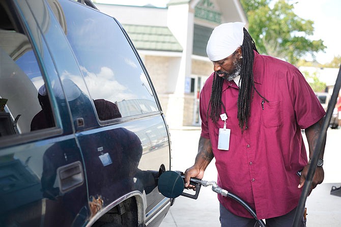 London Nickerson fills his vehicle with gas Tuesday at the Phillips 66 off McCarty and Monroe streets. Gas prices have risen around 30 cents locally as oil companies struggle to get refineries back online after Hurricane Harvey hit southern Texas.