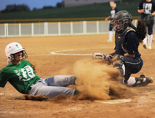 Hannah Schroeder of Blair Oaks is safe at home as Helias catcher Riley Heckenkamp tries to make a tag during the bottom of the first inning in Tuesday night's game at the Falcon Athletic Complex in Wardsville.