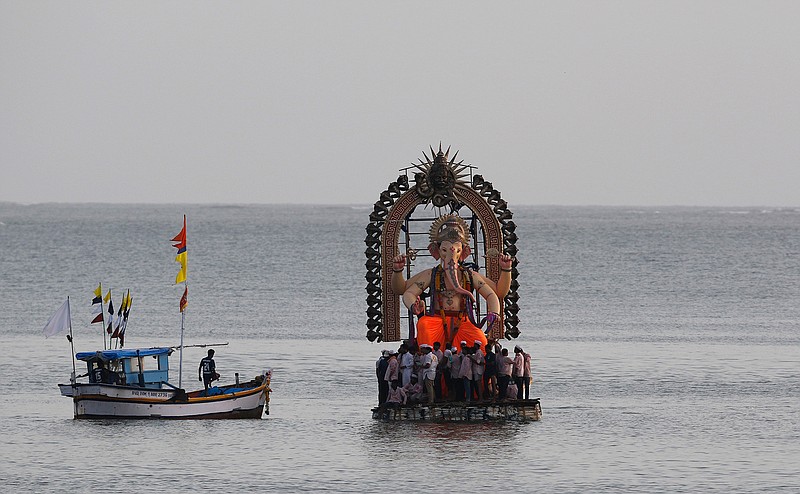 Devotees prepare to immerse an idol of elephant-headed Hindu god Ganesha in the Arabian Sea, marking the end of the 10-day long Ganesh Chaturthi festival in Mumbai, India, Tuesday, Sept 5, 2017.