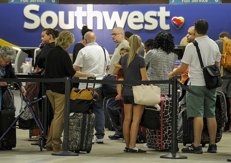 Passengers wait in line at the Southwest Airlines ticket counter Wednesday, Sept. 6, 2017, at Tampa International Airport. Many passengers were leaving Tampa on Wednesday ahead of Hurricane Irma which is threatening the Florida peninsula.