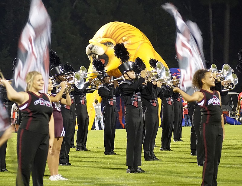 The lion air balloon representing Henderson High looms over the edge of the field as the Atlanta High School Band performs during halftime.
