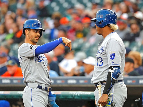 Whit Merrifield (left) of the Royals gestures to Salvador Perez during Tuesday night's game against the Tigers in Detroit.