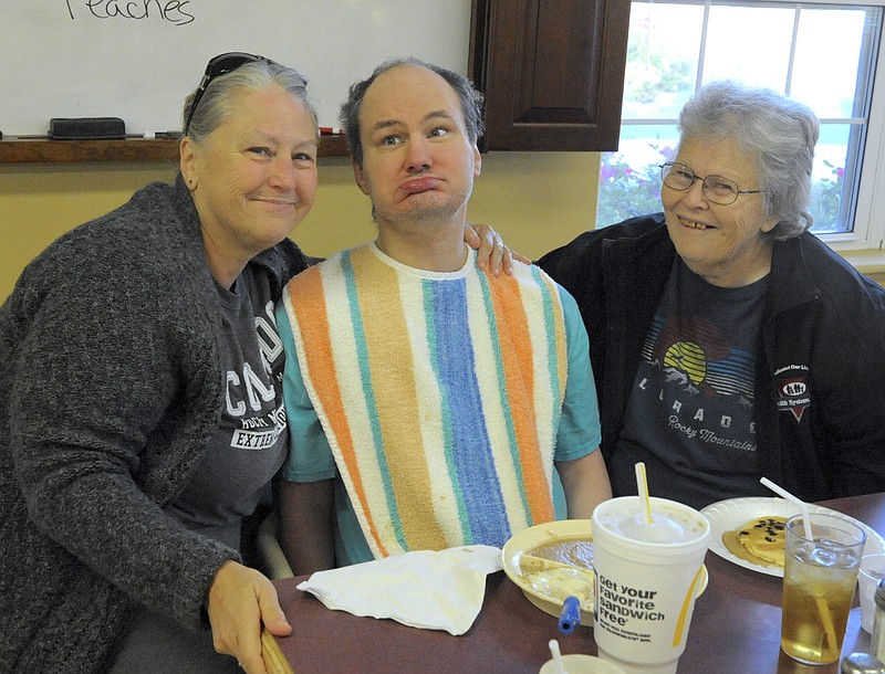 <p>Democrat photo/Michelle Brooks</p><p>Dennis Norvell, a resident at Moniteau Care Center, was visited by his mother, Kaye Dowell, Versailles, and aunt Peggy Simmers, Clarksburg, during the center’s Community Pancake Breakfast Sept. 7.</p>