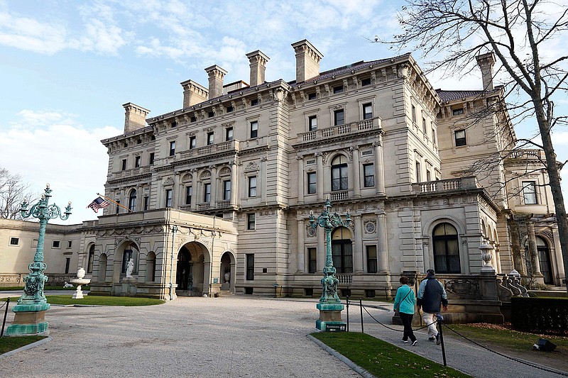 In this Dec. 1, 2014, file photo, visitors walk toward an entrance to The Breakers mansion in Newport, R.I. Visitors to the spectacular Gilded Age mansion are now being allowed to explore its depths with a new tour that shows off the domestic technology that helped make the 70-room, building state-of-the art when it was completed in 1895.