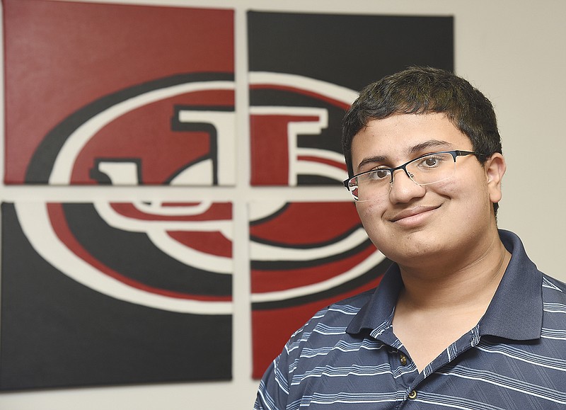 Rakesh Natarajan poses in a Jefferson City High School conference room. Natarajan is a senior who received an award for excellence in research after a summer scholar program that paired him with a scientist at the University of Missouri-St. Louis for six weeks.