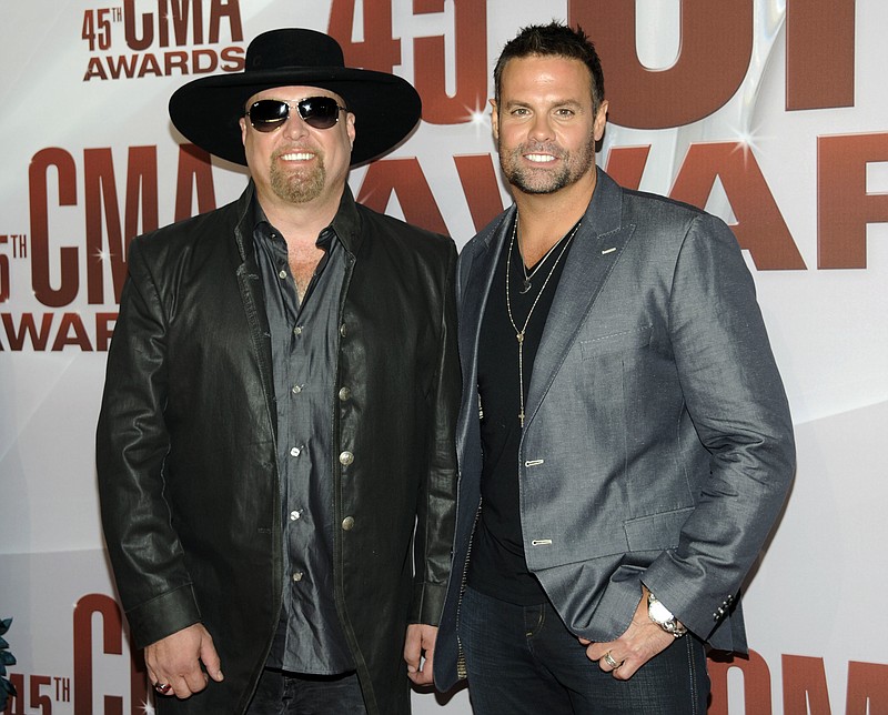 In this Nov. 9, 2011 file photo, Eddie Montgomery, left, and Troy Gentry of Montgomery Gentry arrive at the 45th Annual CMA Awards in Nashville, Tenn. Gentry, one half of the award-winning country music duo Montgomery Gentry, died Friday, Sept. 8, 2017, in a helicopter crash, according to a statement from the band's website. He was 50.  The group was supposed to perform Friday at the Flying W Airport & Resort in Medford, N.J.