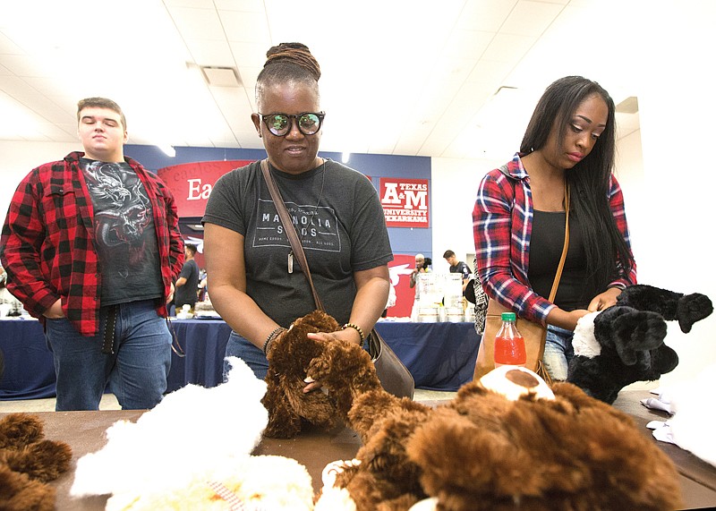Denise Hanson and Shine Tyson build stuffed animals Thursday at Texas A&M-Texarkana. The university celebrated the school mascot ACE's birthday. A&M-Texarkana also celebrates this year's freshman class, its largest with a 16-percent increase over last year.