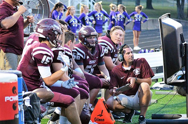 The Versailles defense lines up for a play during its season opener against Knob Noster last month in Versailles.