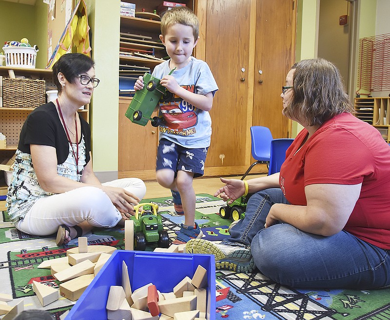 While Karsten Dierking plays with toys at Southwest Early Chilhood Center, his mom, Lisa Dierking, right, visits with Parents as Teachers educator Sara Gretlein. As with home visits and school, Gretlein observes the children, their actions, play style, and interaction with parents and siblings after which she may have suggestions for ways to improve communication, skill development, etc. Dierking is the Family School Advocate at SWECC and Karsten attends the school; both are involved in the PAT program.