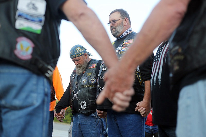 Cecil Goodin,
left, and Jim
Rosenberg pray
Saturday, Sept. 9, 2017 during
a send-off ceremony
for American
Legion
members who
were headed
to Washington,
D.C., to retrieve
flags from the
National Vietnam
Memorial
to escort them
to Perryville.