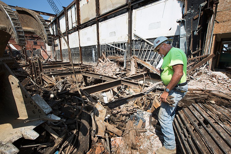 Kenny Townsend, site supervisor with Gator Demolition, talks Friday about the progress he and his crew are making in the removal of the Kress Building in downtown Texarkana, Texas.  