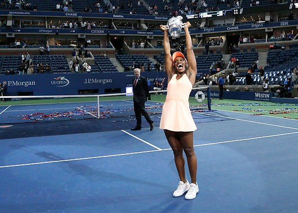 Sloane Stephens holds up the championship trophy after the women's singles final of the U.S. Open on Saturday in New York.