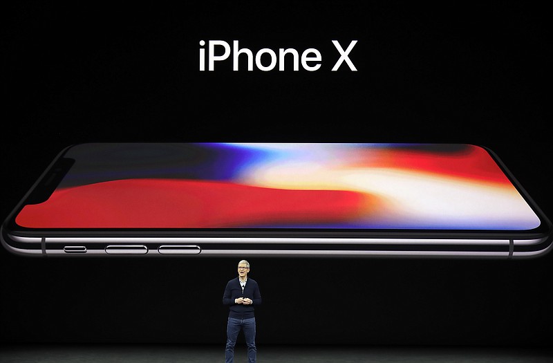 Apple CEO Tim Cook announces the new iPhone X at the Steve Jobs Theater on the new Apple campus, Tuesday, Sept. 12, 2017, in Cupertino, Calif. (AP Photo/Marcio Jose Sanchez)