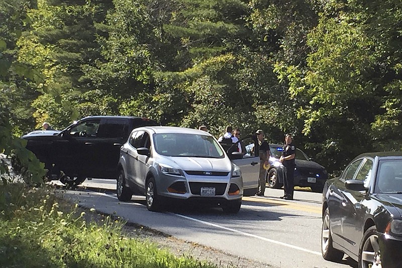 A suspect in an active shooter incident at Dartmouth-Hitchcock Medical Center was pulled from a grey Ford Escape at the intersection of LaHaye Drive and Mount Support Road in Lebanon, N.H., on Tuesday, Sept. 12, 2017. The Lebanon Department of Public Safety confirmed that someone was taken into custody shortly before 3 p.m. following reports of an active shooter at Dartmouth-Hitchcock Medical Center. (Jennifer Hauck/The Valley News via AP)