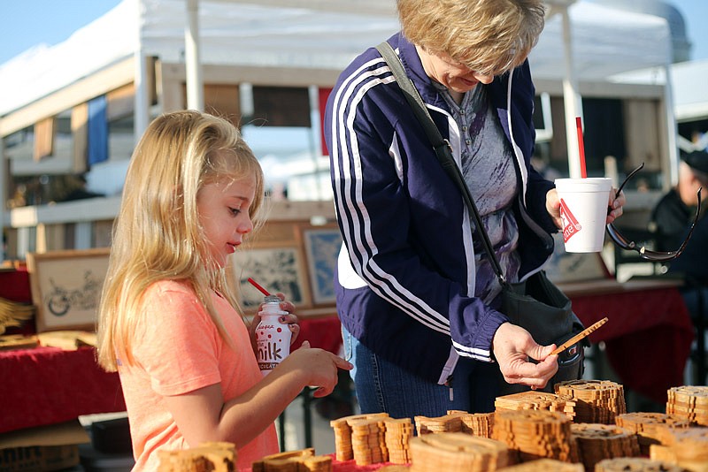 Libby Sandbothe, 6, left, and Linda Distler look at wood carvings during the Cole County Extension Festival held at the Jefferson City Jaycee Fairgrounds in Jefferson City on Saturday, September 09, 2017. 