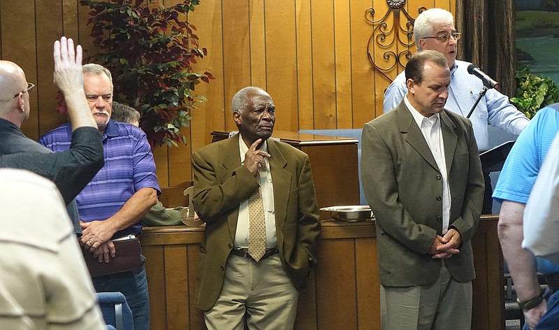 Pastors wait for renewals of faith among those attending a recent revival service at Bethsaida Y Baptist Church. From left are Tony Roberts of Huffines Baptist, George Wilson from Cuba and Chris Miller of Atlanta Church of God. Randy Fisher is leading the song.