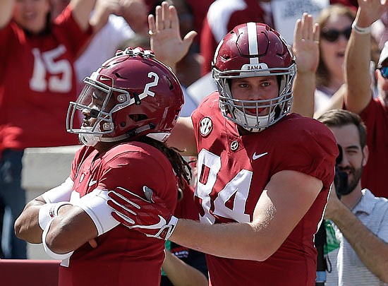 Alabama tight end Hale Hentges (84) celebrates with quarterback Jalen Hurts after Hurts scored a touchdown during the first half of Saturday's win against Fresno State in Tuscaloosa, Ala.