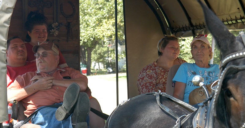 What could be better on a cool, late-summer's day in Atlanta than a wagon ride? Seated in back, from left, are Harvey evacuees Jalynn Bloomer, Grycie Dody and Kristalynn Bloomer from Vidor, Texas. In front are Briane Jackson and Jane Blizzard.