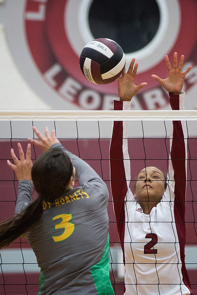 Liberty-Eylau's Kayla Norris gets a finger on the shot by Miller Grove's Rosa Schones during Tuesday evening's match. The Lady Leopards beat the Hornets in straight sets, 25-15, 25-15, 25-20. 