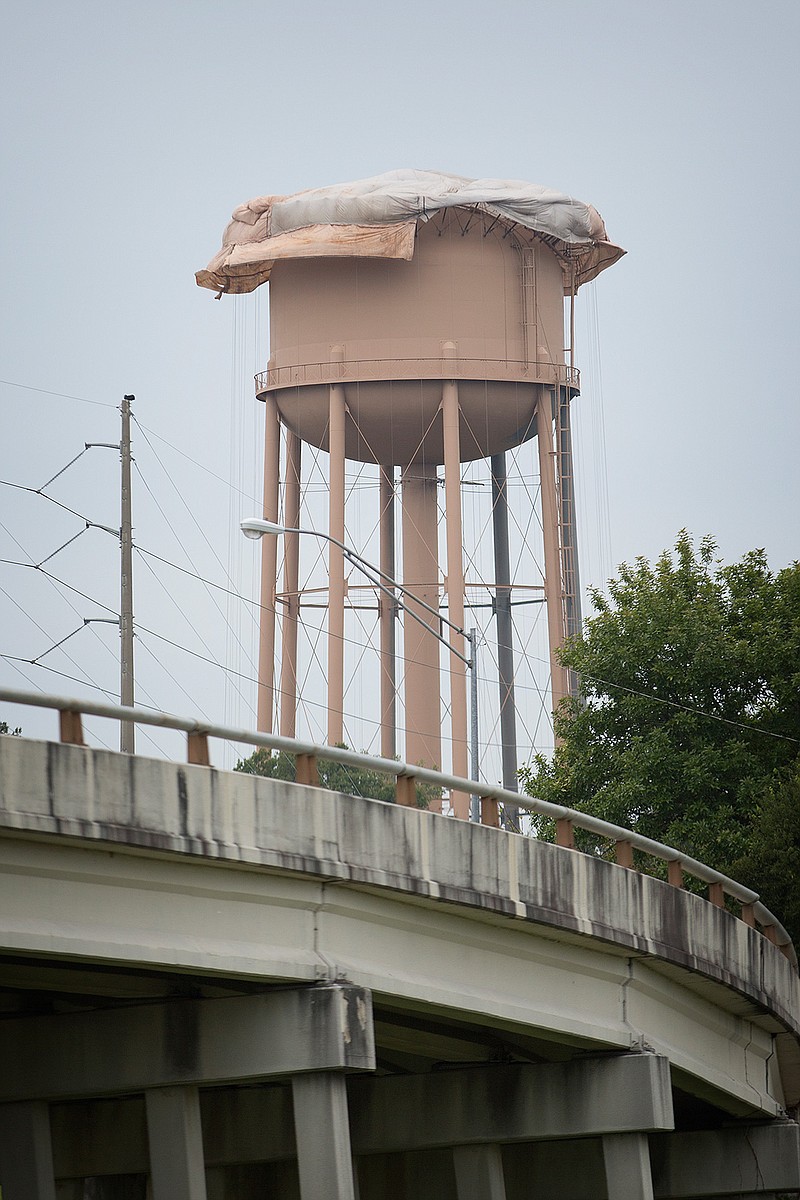 Workers have sandblasted and applied a coat of primer to the tank at Congress and West Fourth streets.