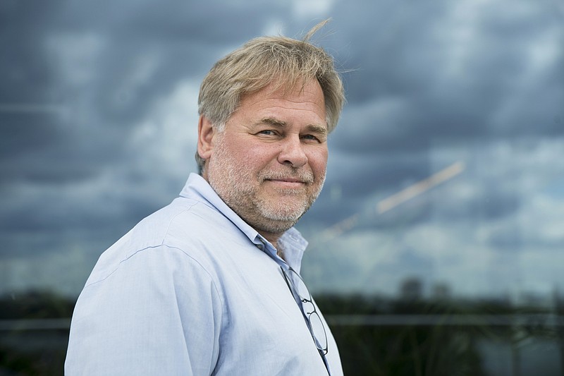 FILE - In this July 1, 2017, file photo, Eugene Kaspersky, Russian antivirus programs developer and chief executive of Russia's Kaspersky Lab, poses for a photo on a balcony at his company's headquarters in Moscow, Russia. On Sept. 13, the U.S. banned the use of computer software supplied by Kaspersky Lab at federal agencies because of concerns about the company’s ties to the Kremlin and Russian spy operations. The directive issued by acting Secretary of Homeland Security Elaine Duke comes as various U.S. law enforcement and intelligence agencies and several congressional committees are investigating Russian meddling in the 2016 presidential election. (AP Photo/Pavel Golovkin, File)