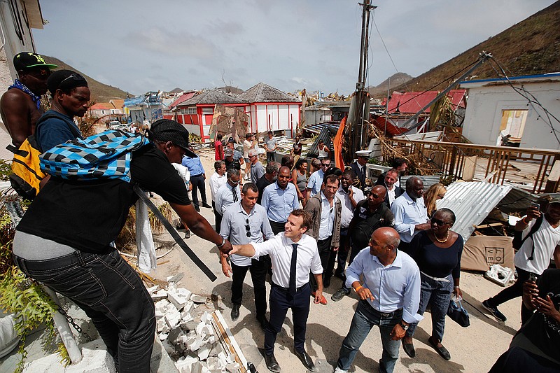 France's President Emmanuel Macron shakes hands with residents during his visit in the French Caribbean islands of St. Martin , Tuesday, Sept. 12, 2017. Macron is in the French-Dutch island of St. Martin, where 10 people were killed on the French side and four on the Dutch.