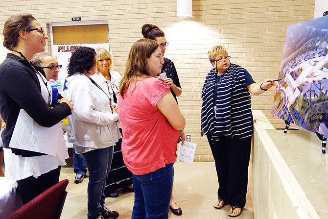 Dr. Sharon Robbins, right, director of psychology at the Fulton State Hospital, points out features of the Nixon Forensic Center to a crowd of FSH employees. The facility is in construction and on track to be completed in late 2018.