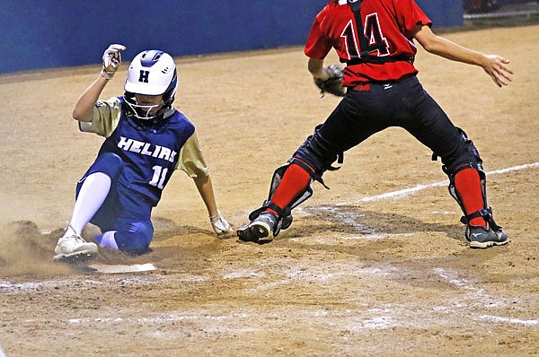 Taylor Woehr of Helias slides into home past Southern Boone catcher Kate Ponder to score a run during the fifth inning of Tuesday night's game at the American Legion Post 5 Sports Complex.