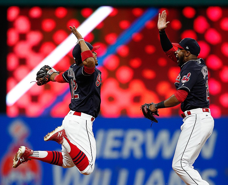Cleveland Indians' Francisco Lindor, left, and Austin Jackson celebrate a 2-0 victory over the Detroit Tigers in a baseball game, Tuesday, Sept. 12, 2017, in Cleveland.