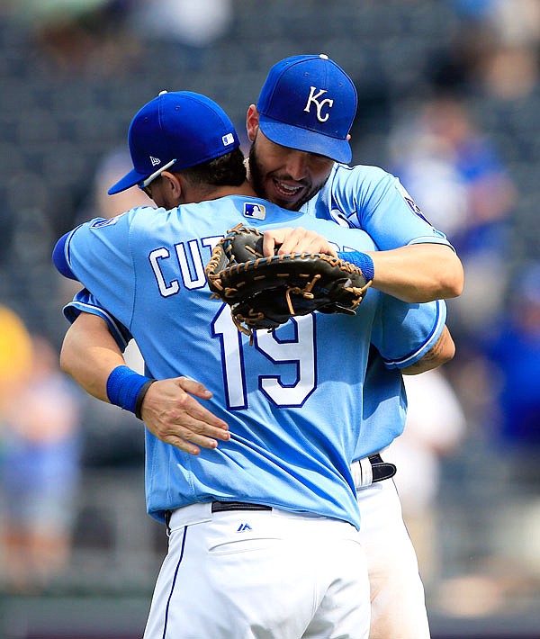 Royals first baseman Eric Hosmer and third baseman Cheslor Cuthbert hug following Tuesday afternoon's game against the White Sox at Kauffman Stadium in Kansas City.