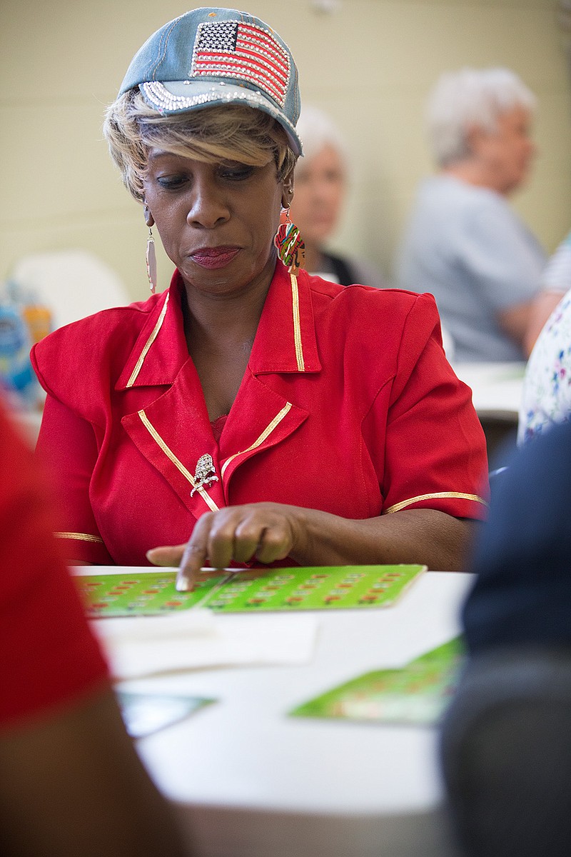 Allene Starks plays bingo Wednesday at Collins Senior Center. The Texarkana, Texas, Parks Department held an open house Wednesday to showcase the center's services.