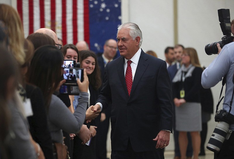 U.S. Secretary of State Rex Tillerson shakes hands with staff,  at the U.S Embassy in London, Thursday, Sept. 14, 2017, during his second visit to Britain since taking office in February.  (Hannah McKay/Pool Photo via AP)