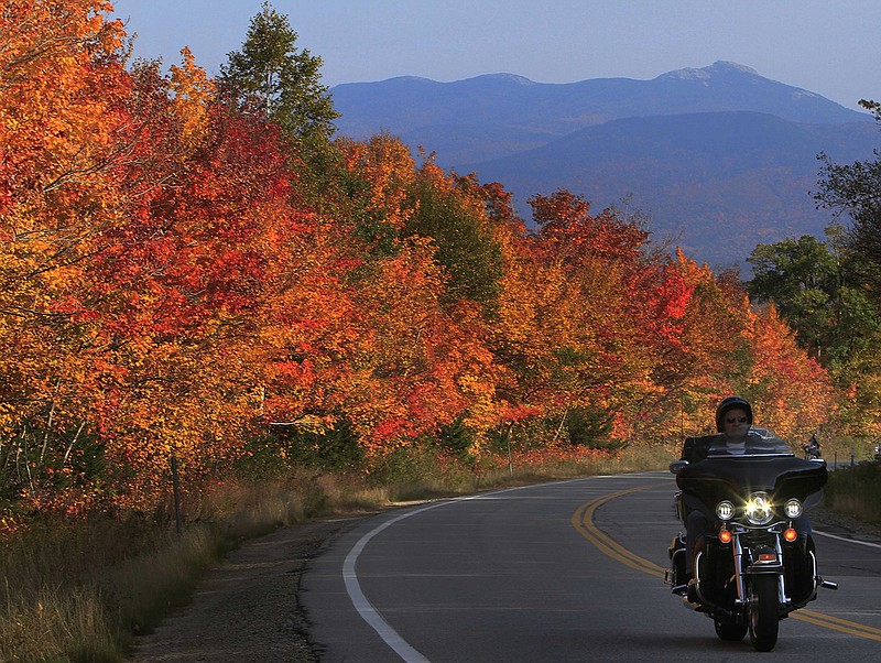 In this Oct. 5, 2012, file photo, peak colors are seen along the Kancamagus Highway in Albany, N.H. The nearby Boulder Loop Trail in Conway offers fall colors and a way to get your steps in while enjoying the foliage.