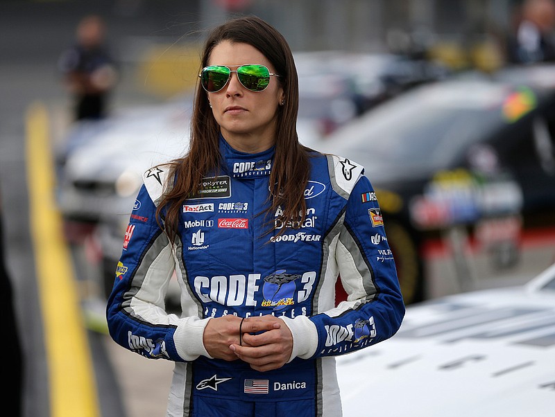 In this Thursday, May 25, 2017 file photo, Danica Patrick stands by her car before qualifying for Sunday's NASCAR Cup series auto race at Charlotte Motor Speedway in Concord, N.C. Danica Patrick is done at Stewart-Haas Racing and her future in NASCAR is now up in the air amid a sponsorship shake-up. Patrick posted a statement on her Facebook page Tuesday, Sept. 12, 2017 saying her time with Stewart-Haas "had come to an end" due to a new sponsorship arrangement for the team next season.