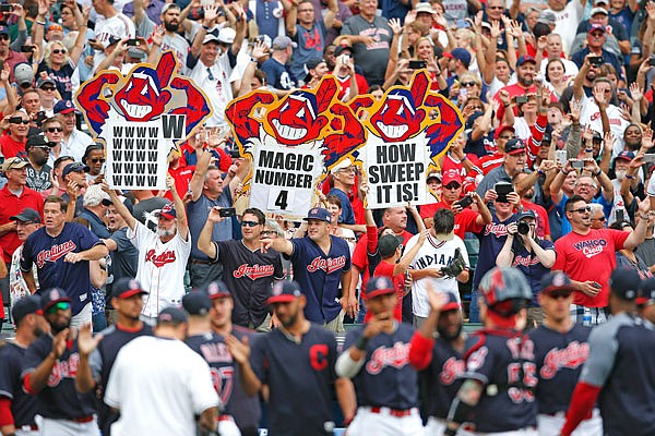 Indians fans celebrate Wednesday's 5-3 victory against the Tigers in Cleveland. The Indians set the American League record with 21 consecutive wins.