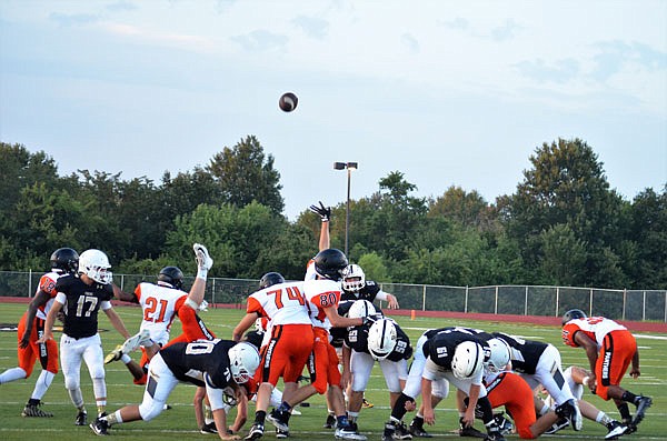 The Versailles Tigers convert a kick during their season-opener against Knob Noster.