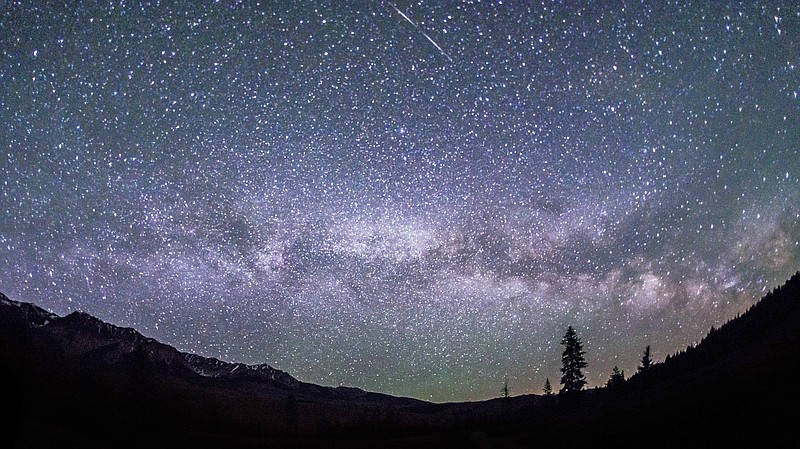 This June 4, 2016 photo provided by Nils Ribi Photography shows the Milky Way in the night sky at the foot of the Boulder Mountains in the Sawtooth National Recreation Area, Idaho. Tourists heading to central Idaho will be in the dark if local officials get their way. The nation's first International Dark Sky Reserve will fill a chunk of the sparsely populated region containing night skies so pristine that interstellar dust clouds are visible in the Milky Way. (Nils Ribi Photography via AP)