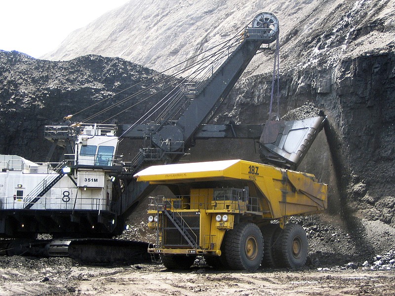 FILE - In this April 30, 2007, file photo, a shovel prepares to dump a load of coal into a 320-ton truck at the Arch Coal Inc.-owned Black Thunder mine in Wright, Wyo. A federal appeals court has sided with environmentalists trying to block mining at the two biggest coal mines in the U.S. on the grounds the coal contributes to climate change. (AP Photo/Matthew Brown, File)