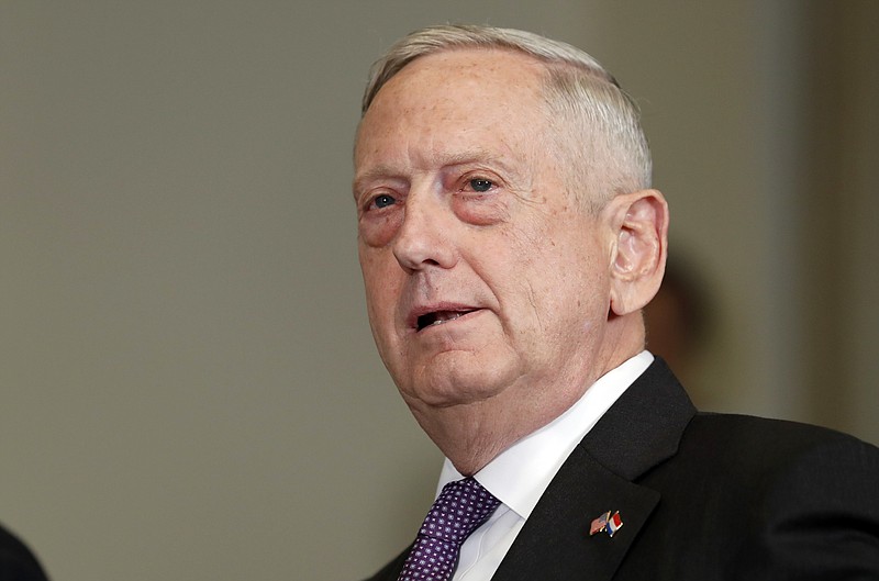 FILE - In this Aug. 15, 2017, file photo, Defense Secretary Jim Mattis speaks at the Pentagon. New guidance released by the Pentagon on Sept. 15, makes it clear that any transgender troops currently in the military can re-enlist in the next several months, even as the department debates how broadly to enforce a ban on their service ordered by President Donald Trump. (AP Photo/Alex Brandon, File)