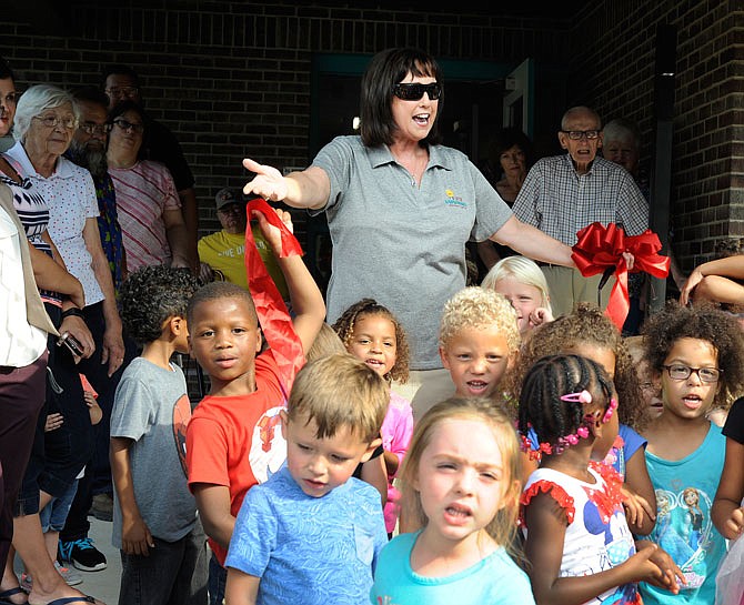 Donna Scheidt encourages the children to sing to the guests Thursday, Sept. 14, 2017, at Jefferson City Day Care's 50th anniversary party. The children delivered a rendition of "Be Our Guest" from "Beauty and the Beast" to thank United Way for their sponsorship.