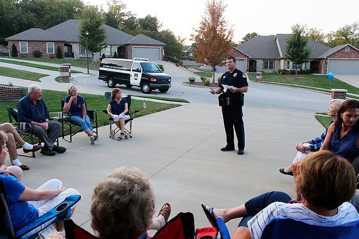 Neighborhood Watch Coordinator Josh Hagemeyer speaks to a group of Country Club Estates neighbors about common sense security measures around the house.