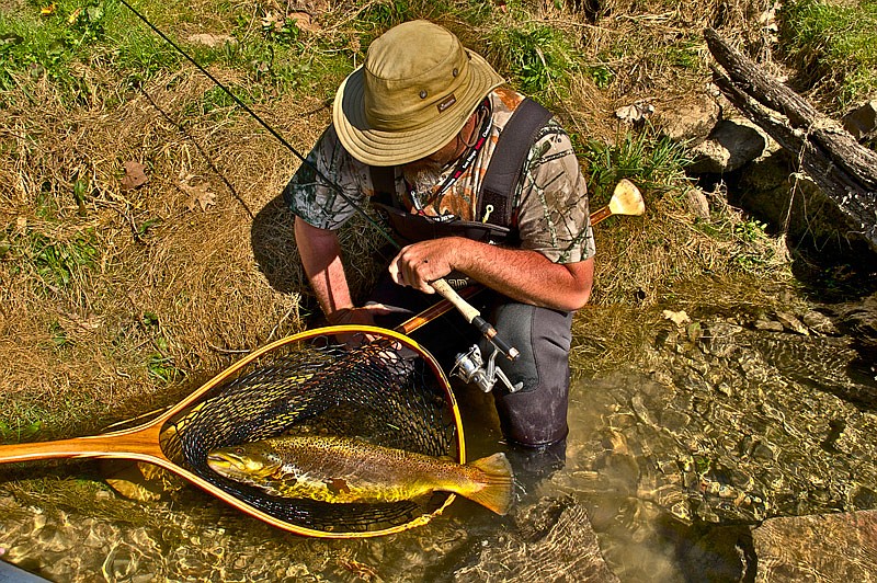 "Paddle Don" Cranfill of Bloomington, Ind., admires his 12-pound, 11-ounce White River brown trout.