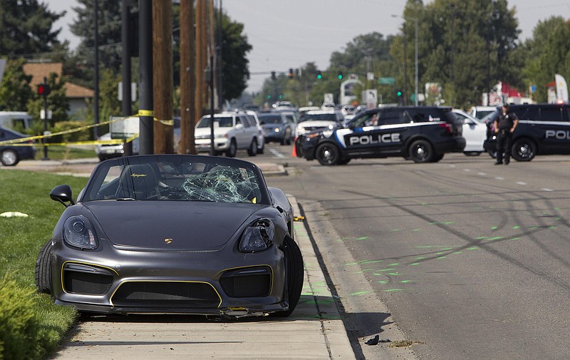 Police block off the scene were the driver of a Porsche injured eight bystanders after losing control of the sports car near the Boise Spectrum 21 theaters Saturday, Sept. 16, 2017 in Boise, Idaho. Police say the driver of the gray Porsche accelerated rapidly while leaving the Cars and Coffee event but lost control and ran into the nearby crowd. Ambulances took six people to hospitals and two others were taken by private vehicles. Police didn't provide any names or conditions.  (Darin Oswald/Idaho Statesman via AP)