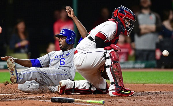 Lorenzo Cain of the Royals slides safely into home to score on a RBI-single by Eric Hosmer while  Indians catcher Roberto Perez blocks the ball in the fifth inning of Friday night's game in Cleveland.