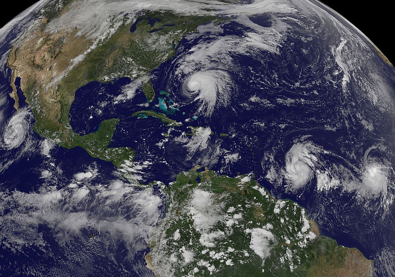 This image made available by the NOAA-NASA GOES Project shows tropical weather systems Hurricane Norma, left, on the Pacific Ocean side of Mexico; Jose, center, east of Florida; Tropical Depression 15, second from right, north of South America, and Tropical Storm Lee, right, north of eastern Brazil, on Saturday, Sept. 16, 2017 at 2:45 p.m. EDT. (NOAA-NASA GOES Project via AP)