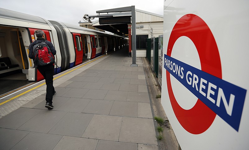 Travellers walk on the platform at Parsons Green tube station following Friday's incident on a tube at Parsons Green Station in London, Sunday, Sept. 17, 2017. A manhunt is under way after an improvised explosive device was detonated on a crowded subway car, injuring at least 29 people. (AP Photo/Frank Augstein)