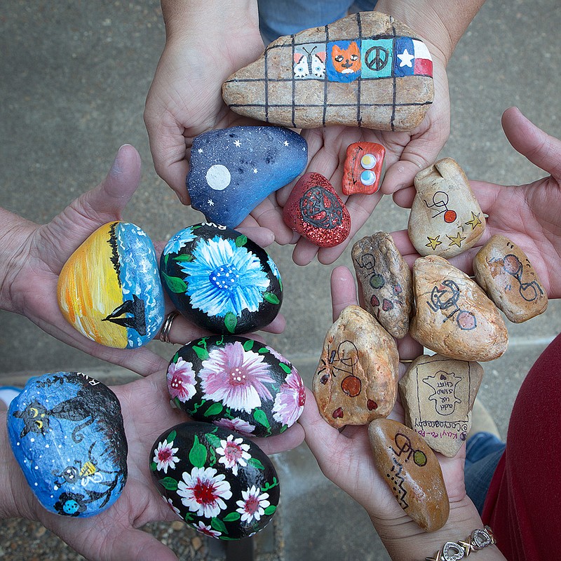 Rochelle Walk, Stephanie Schutte and Stephanie Pond show some of the rocks they have either painted or collected. 