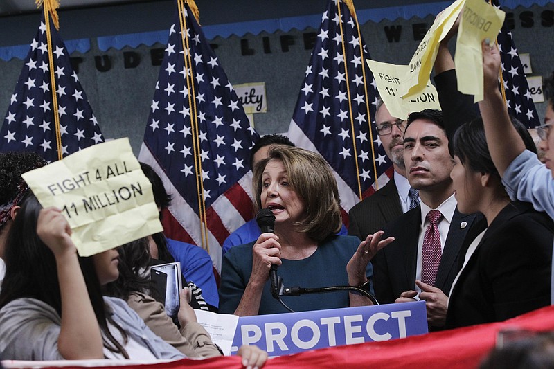 <p>AP</p><p>U.S. House Minority Leader Nancy Pelosi tries to talk as protesters demonstrate during a press conference on the DREAM ACT on Monday.</p>